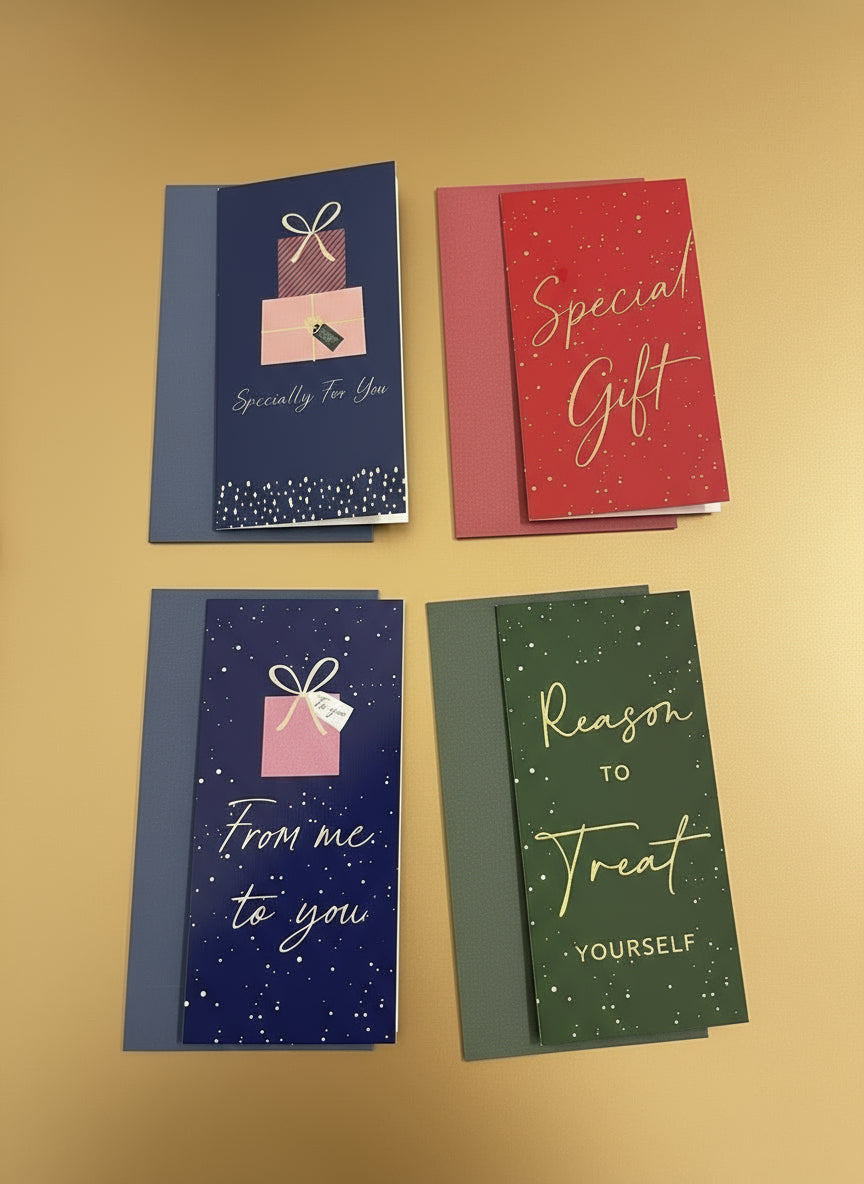 Four gift cards in blue, red, and green on a dark surface