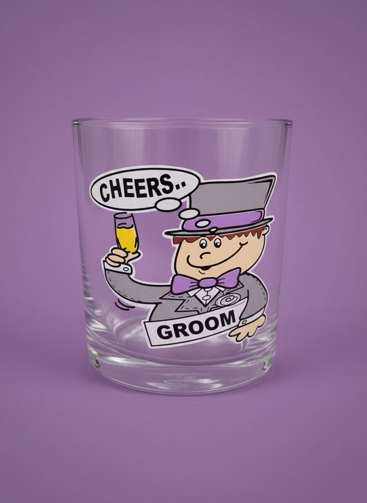 Clear shot glass with cartoon character and 'Cheers Groom' text on a purple background